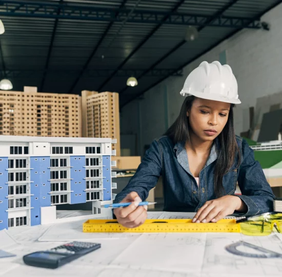 african-american-woman-safety-helmet-working-near-model-building~1
